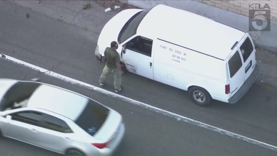 The suspect later took off and pulled over at the Long Beach Boulevard exit, got out of the van and began running away before returning to the vehicle. (KTLA)