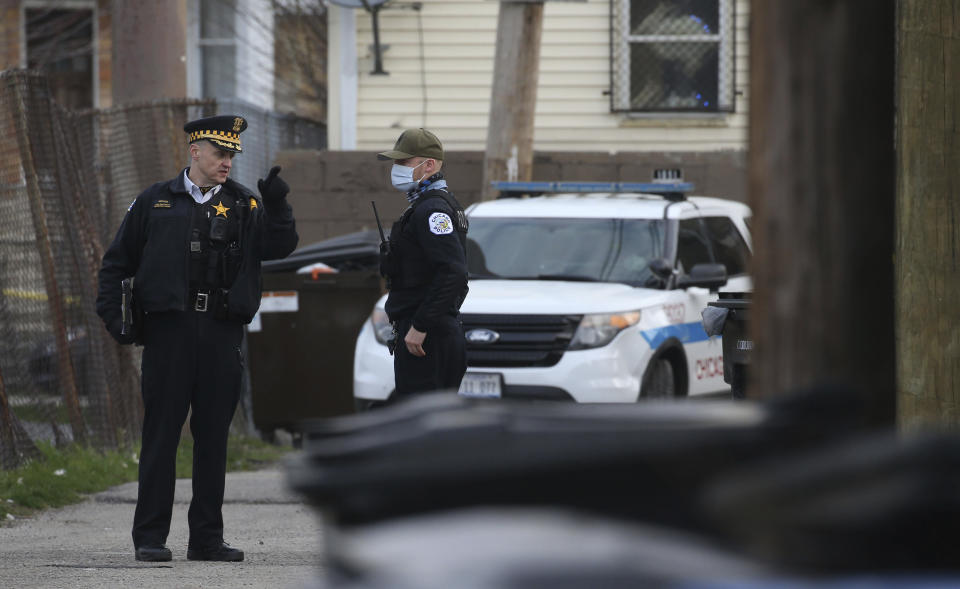 Police work at the scene of a fatal shooting of a 13-year-old boy by a Chicago Police officer on Monday, March 29, 2021 in Chicago. Calls for the release of body camera video of the fatal shooting of the 13-year-old boy by a Chicago Police officer are growing louder both within and outside the department. As the agency that investigates police shootings says it is investigating if there is a legal way to release the video of Monday's shooting of Adam Toledo, Police Superintendent David Brown and Mayor Lori Lightfoot both say it should be released. (Antonio Perez/Chicago Tribune via AP)