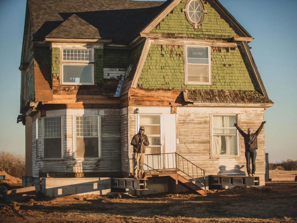 Eddie and Julie outside of their house in its new location.