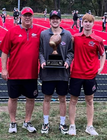 New Holy Cross football coach Curt Spencer (left) with his sons Brady and Hayden who both attended Holy Cross High School