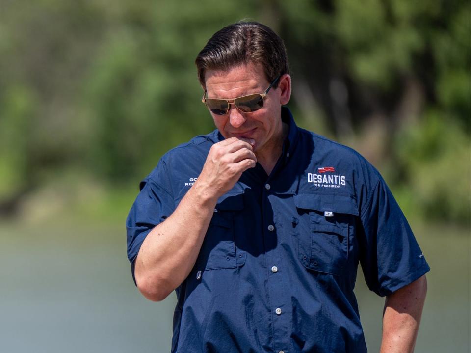 Ron DeSantis stands on the banks of the Rio Grande during a press conference in Eagle Pass, Texas, in June (Getty Images)