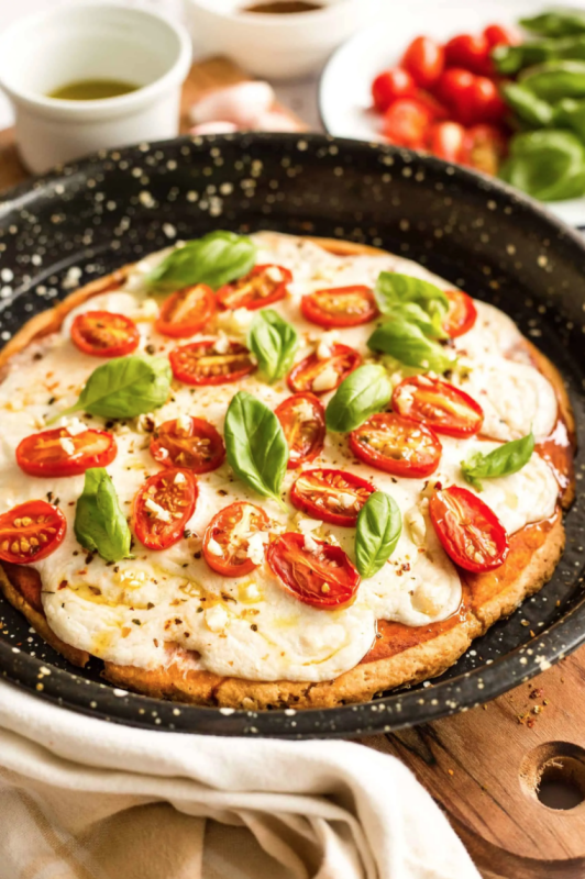 Dish by Dish<p>This gluten-free caprese pizza is the combination of a perfect crust topped with simple ingredients that carry big, bold flavors. Dairy-free and vegan too.</p><p><strong>Get the recipe: <a href="https://www.dishbydish.net/caprese-pizza-gluten-free-dairy-free-vegan/" rel="sponsored" target="_blank" data-ylk="slk:Easy Caprese Pizza (Gluten-Free, Vegan);elm:context_link;itc:0;sec:content-canvas" class="link "><em>Easy Caprese Pizza (Gluten-Free, Vegan)</em></a></strong></p>