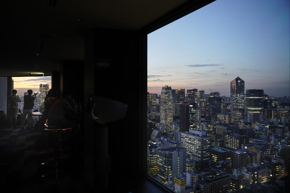 People take pictures of Tokyo's skyline during sunset from the Seaside Top observatory located on the 40th floor of the World Trade Center, Wednesday, Sept. 25, 2019, in Tokyo. (AP Photo/Jae C. Hong)