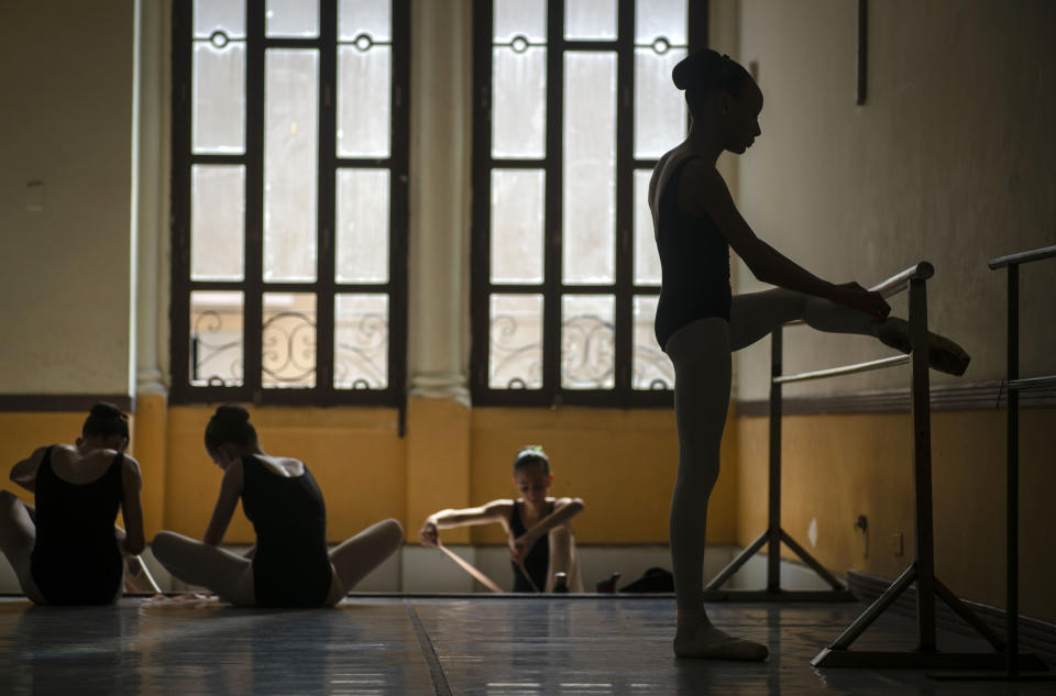 Dancers prepare for a class at the National Ballet School, in Havana, Cuba, Thursday, Oct. 17, 2019. The revered ballerina and choreographer Alicia Alonso whose nearly 75-year career made her an icon of artistic loyalty to Cuba's socialist system, died Thursday, at age 98. (AP Photo/Ramon Espinosa)