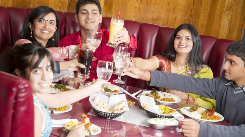 indian family cheersing at restaurant