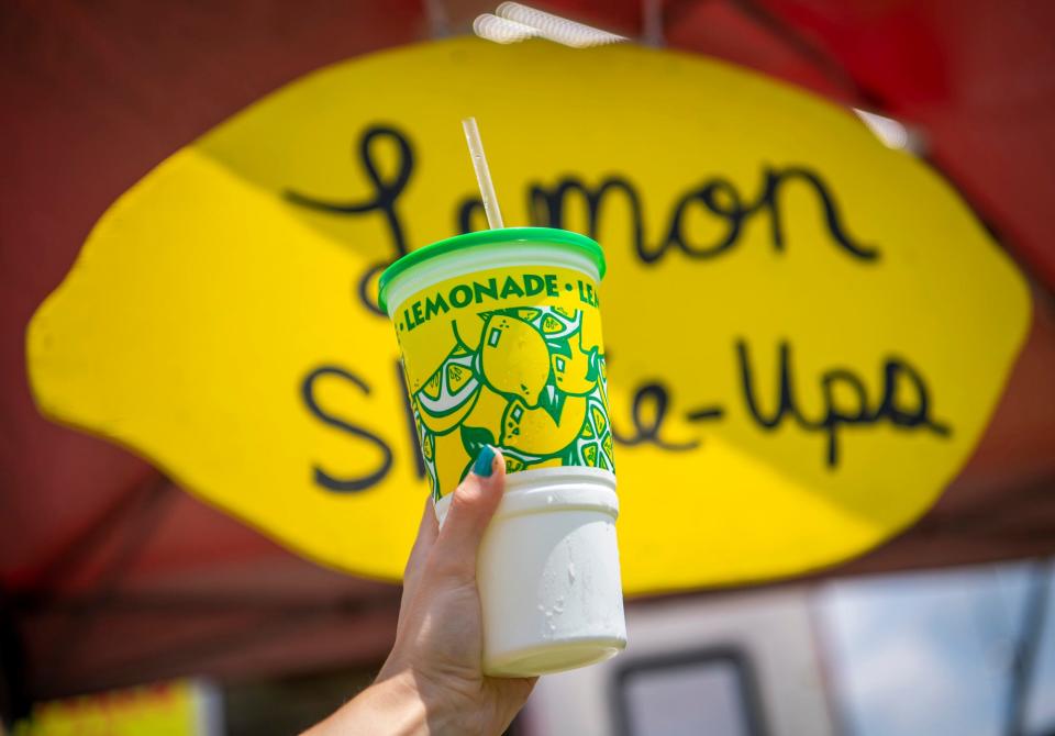 Herald-Times reporter Maya Gray holds a lemon shake-up from Weenie Wagon at the Monroe County Fair at the Monroe County Fairgrounds on Monday, July 3, 2023.