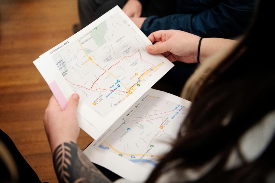 A volunteer point in time group looks at the map of their assigned neighborhood near Charlotte Street January 31, 2023.