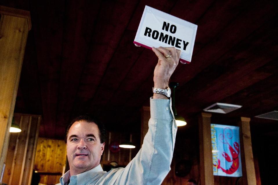 Jeff Giles, a Republican delegate of Houma, holds up an Etch A Sketch with a "NO ROMNEY" banner, during Republican presidential candidate Newt Gingrich's campaign stop at Big Al's Seafood Restaurant on Thursday, March 22, 2012 in Houma, La. (AP Photo/The Houma Daily Courier, Michael Conti) MAGS OUT; NO SALES; MANDATORY CREDIT