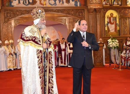 Egyptian Coptic Pope Tawadros II (L), Pope of Alexandria and Patriarch of Saint Marc Episcopate receives Egyptian President Abdel Fattah al-Sisi (R), at the new Coptic Cathedral at the new Coptic Cathedral "The Nativity of Christ" in the new administrative capital, 45 km east of Cairo, Egypt January 6, 2018. in this handout picture courtesy of the Egyptian Presidency. The Egyptian Presidency/Handout via REUTERS