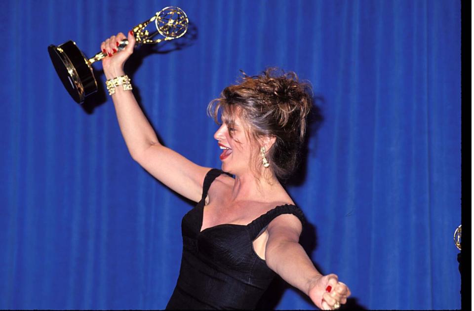 Kirstie Alley holds up her Emmy.