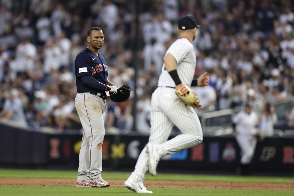 Boston Red Sox's Rafael Devers talks to New York Yankees left fielder Jake Bauers after flying out during the third inning of a baseball game Saturday, June 10, 2023, in New York. (AP Photo/Adam Hunger)