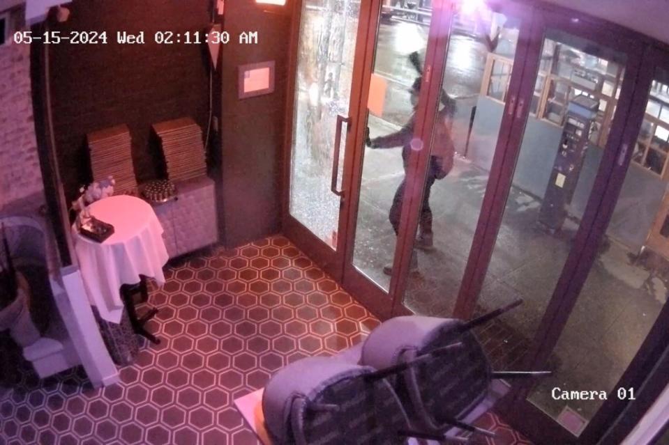 The unidentified vandal is shown in surveillance footage from inside the restaurant, ready to strike the door. Provided by Rothschild TLV