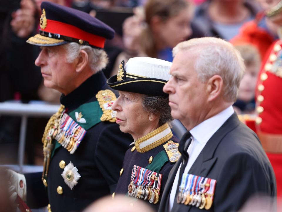 King Charles III, Princess Anne, and Andrew, Duke of York, walk behind Queen Elizabeth II's Coffin as it heads to St Giles Cathedral