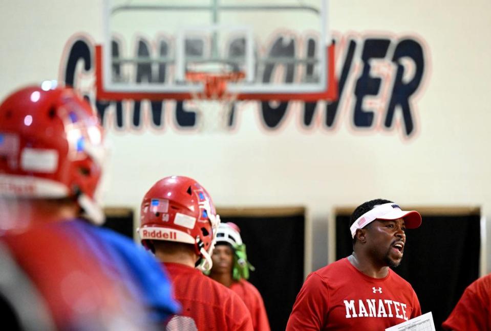 The Manatee Hurricanes High School football team practice indoors in the JROTC gym on the campus as the heat index pushed 94 outside. Coach Jacquez Green works with players.