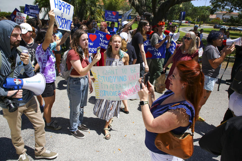 Protesters gather at the New College of Florida campus moments after Gov. Ron DeSantis signed legislation there on Monday, May 15, 2023, in Sarasota, Fla. DeSantis signed a bill that blocks public colleges from using federal or state funding on diversity programs, addressing a concern of conservatives ahead of the Republican governor's expected presidential candidacy. The law, which DeSantis proposed earlier this year, comes as Republicans across the country target programs on diversity, equity and inclusion in higher education. (Douglas R. Clifford/Tampa Bay Times via AP)