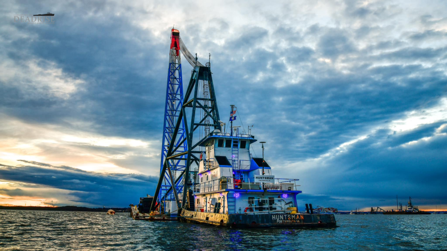 <em>The “Samson” crane and Huntsman tugboat from Portsmouth-based CROFTON are moored in the Patapsco River in sight of the Francis Scott Key bridge wreckage (Courtesy: Mark Hergan/Deadrise Marine Photography)</em>