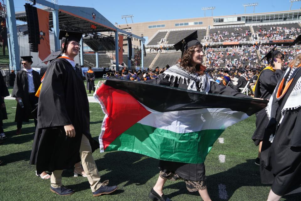 Some graduates showed their support for Palestinians and protested the war in Gaza as they enter Tiger Stadium to Princeton University’s 277th Commencement.