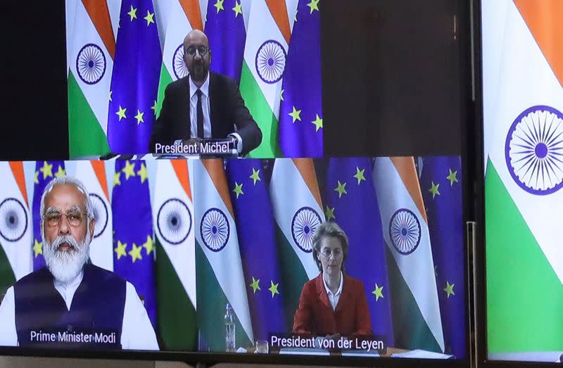 European Council President Charles Michel, Ursula von der Leyen and Indian Prime Minister Narendra Modi are seen on the monitor as they take part in a virtual summit, in Brussels