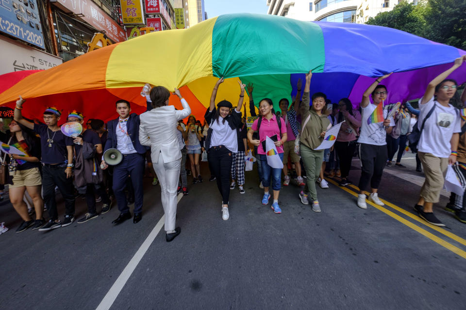 TAIPEI, TAIWAN - 2018/10/27: flying a huge rainbow flag, participants at the annual Taiwan Pride, an LGBT organized event, parade along the Taipei city center streets. The vent is so far the largest of its kind held in the country and possibly in the whole of Asia as it was estimated that over 100, 000 people took part. (Photo by Alberto Buzzola/LightRocket via Getty Images)