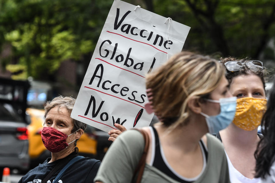 A demonstrator holds a sign saying 