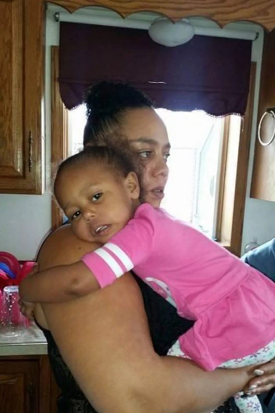 This photo provided Anthony LaCour shows his wife, Jerica LaCour, of Colorado Springs, Colo., holding one of their five children. (Anthony LaCour via AP)