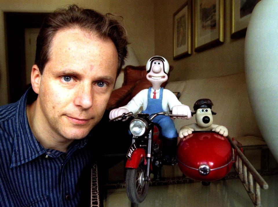 Nick Park of Britain poses with his creations, plasticine figures Wallace (C) and Gromit, (R) in a New York hotel October 21. Wallace and Gromit, who appeared in the 1996 Oscar winning animated short film "A Close Shave", were returned to Park after being left in a taxi October 19.