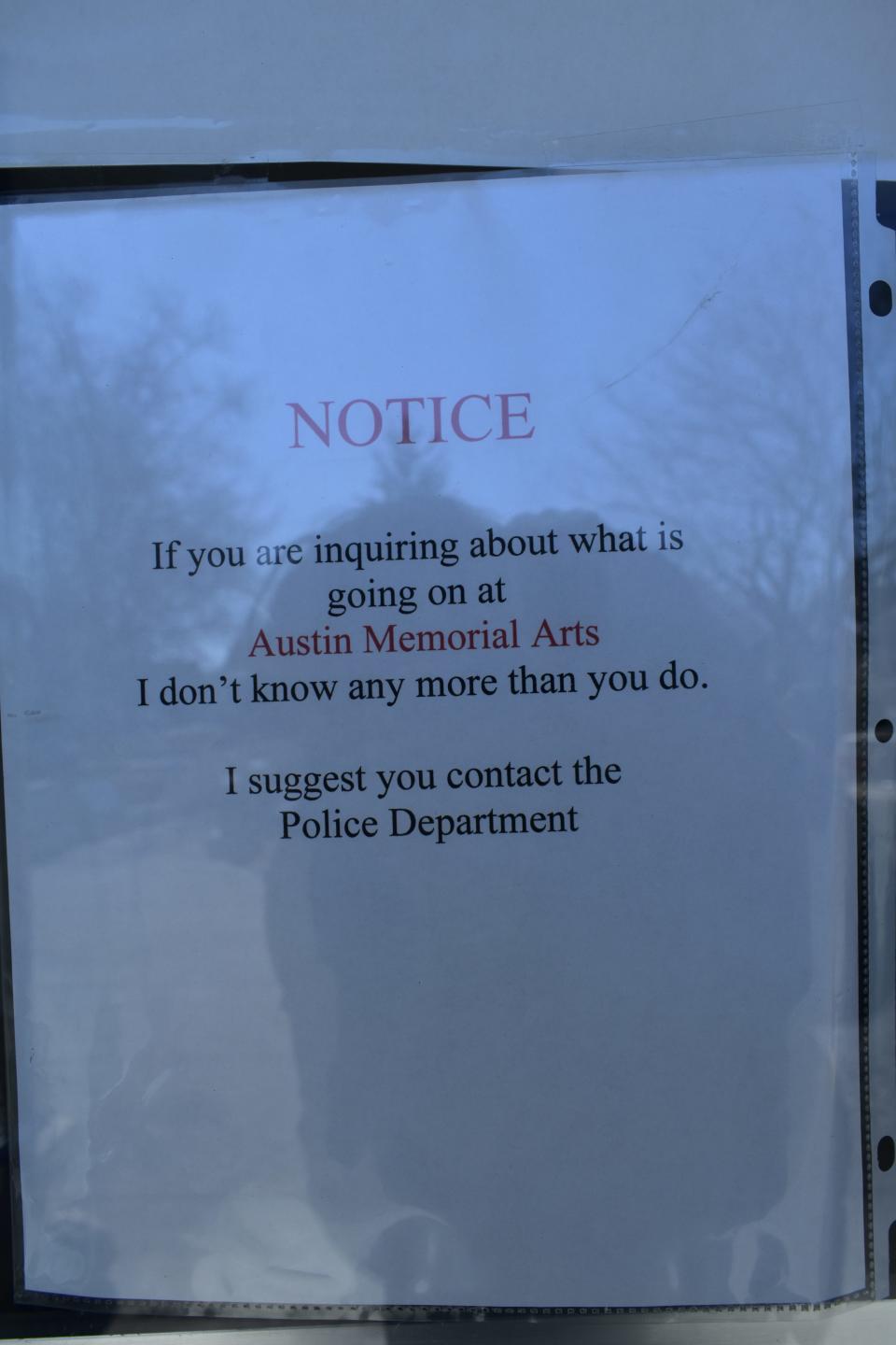 A sign on the entry door at Holt Monument Works in Bloomfield informs customers that employees have no knowledge of troubles at nearby Austin Memorial Arts, a competitor in the area gravestone industry.