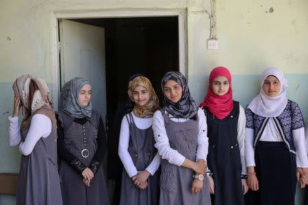 Pupils stand in from their classroom at an elementary school in eastern Mosul, Iraq, April 17, 2017. REUTERS/Marko Djurica