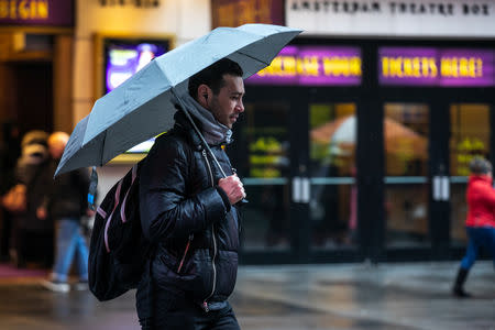 A pedestrians walks in the rainy day near Time Square in the Manhattan borough of New York City, New York, U.S., January 20, 2019.REUTERS/Jeenah Moon