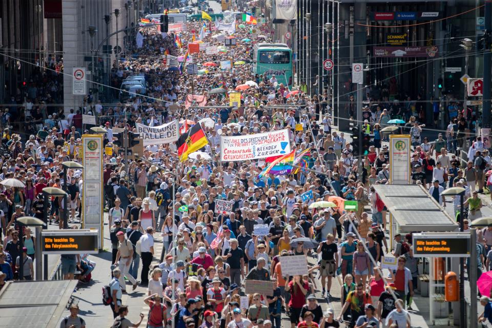 Thousands march along the 'Friedrichstrasse' during the demonstration against corona measures in Berlin, Germany, Saturday, Aug. 1, 2020.