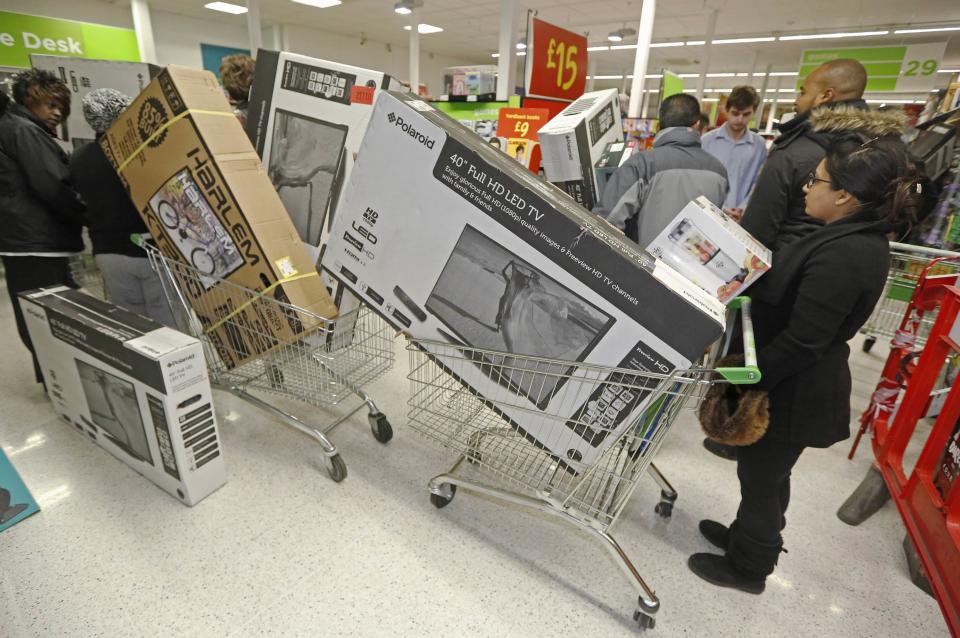 Shoppers queue to purchase retail items on "Black Friday" at an Asda superstore in Wembley, north London