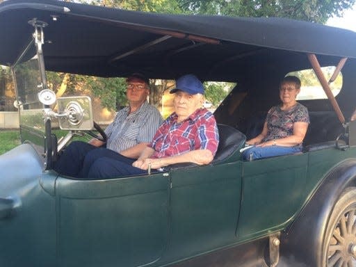 D.A. Crist, the unofficial historian of Gove County, Kansas, sits in the front seat of a right-hand drive 1915 Pierce Arrow car being driven by his son Dan, with Dan's wife Janice in the back seat, in this undated photo. D.A. Crist died of coronavirus Oct. 12, 2020.