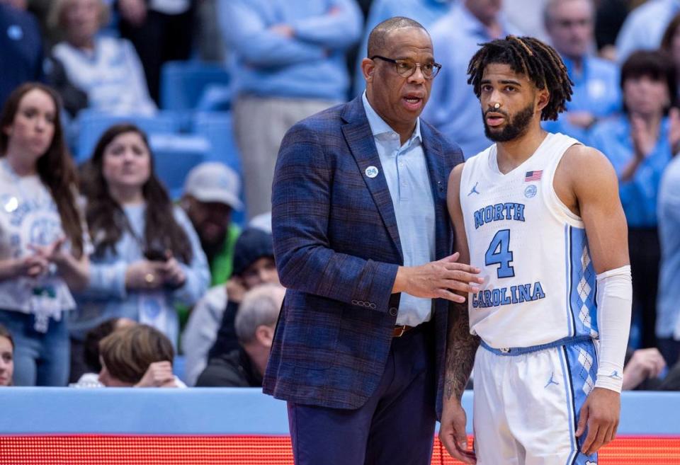 North Carolina coach Hubert Davis talks with R.J. Davis (4) during the final minutes of play against Miami on Monday, February 26, 2024 at the Smith Center in Chapel Hill, N.C.