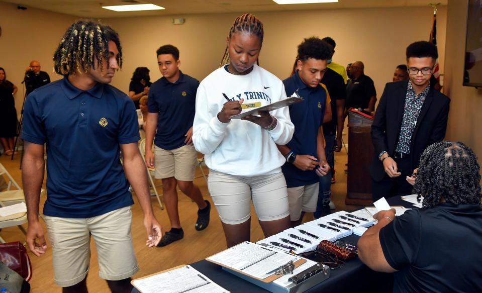 Students register to vote at the close of a National Voting Registration Day event on Sept. 20 at the Harry T. And Harriette V. Moore Memorial Park and Museum in Mims. The Faith in Florida event included several speakers and young people registering to vote.