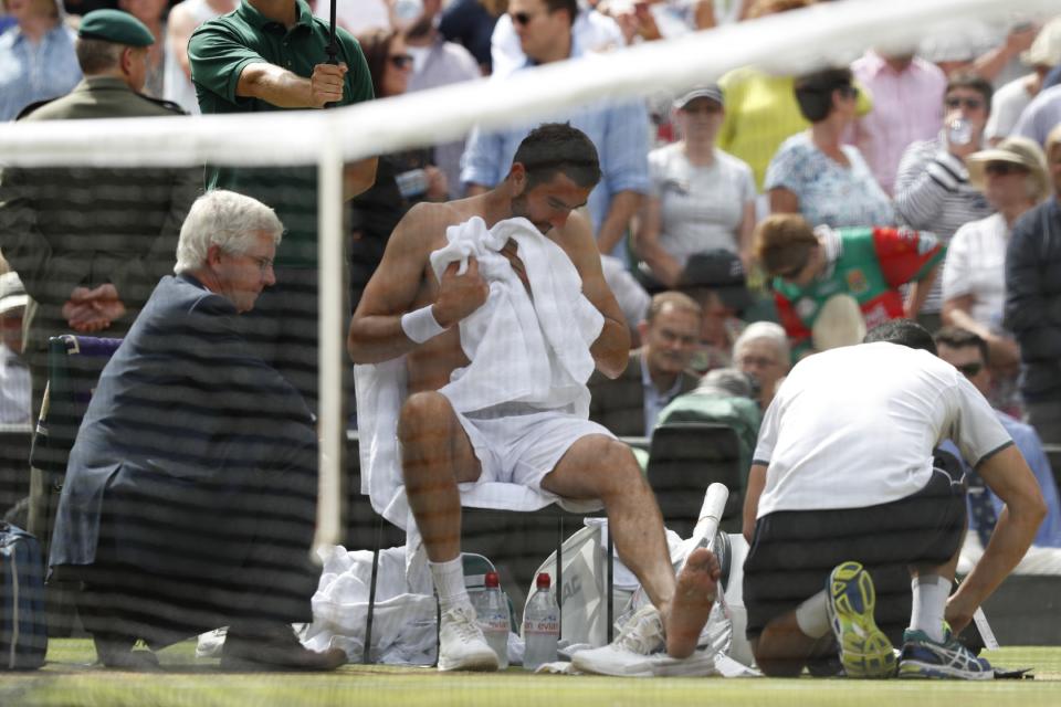 Cilic gets treatment on court (AFP).