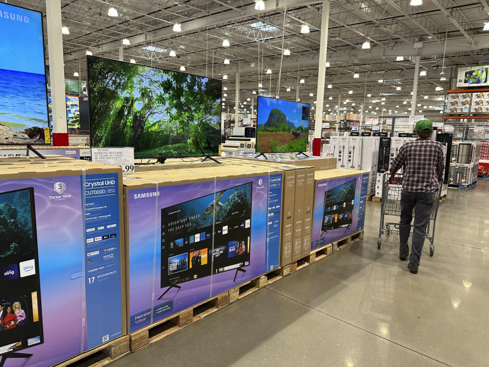 A shopper passes a display of big-screen televisions in a Costco warehouse Thursday, Jan. 11, 2024, in Sheridan, Colo. On Wednesday, the Commerce Department releases U.S. retail sales data for December. (AP Photo/David Zalubowski)