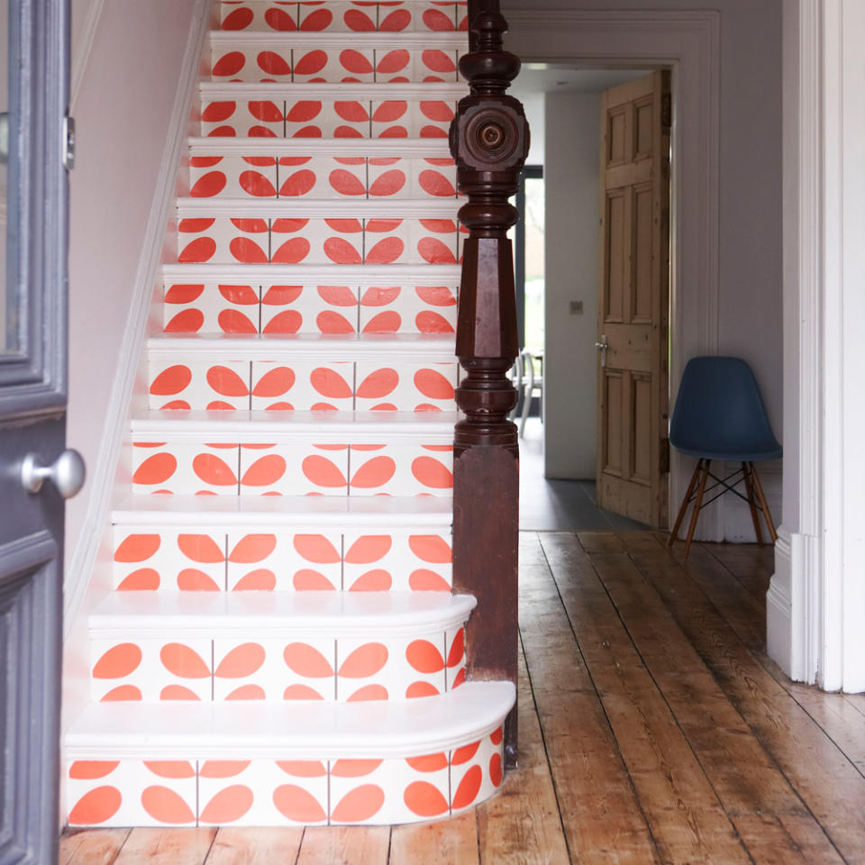 hallway with wooden flooring and stairs wallpaper