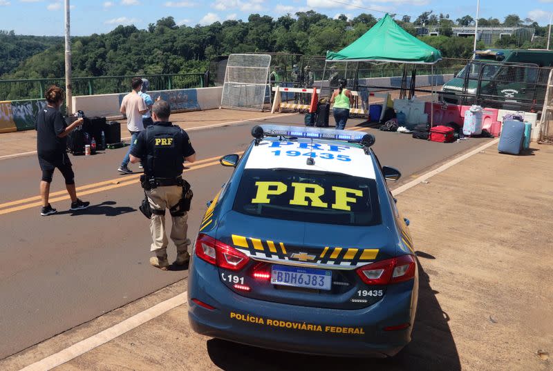 Brazilian Federal Highway Police officers are seen at the Tancredo Neves Bridge, on the border with Argentina, blocked by the Argentine government, during the coronavirus disease (COVID-19) outbreak, in Foz do Iguacu