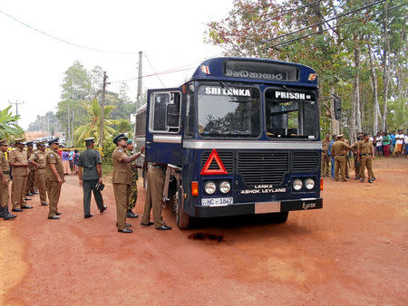 Sri Lanka's police officers inspect a prison bus after gunmen opened fire in Colombo, Sri Lanka February 27, 2017. REUTERS/Stringer