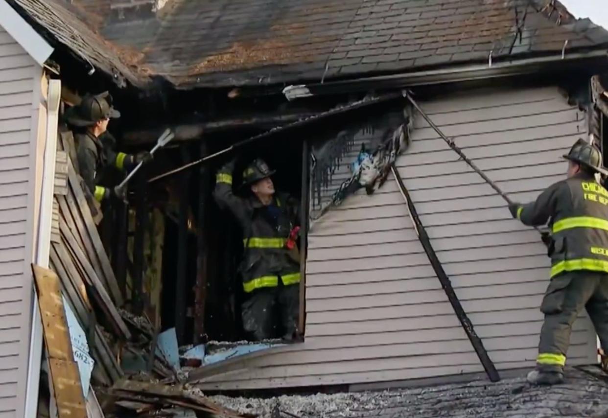 Firefighters investigate the cause of why Tatianna's home burned. (Credit: CBS Chicago)