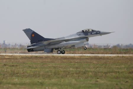 A F-16 plane touches down at 86th Air Base of Romanian Air Force after performing a flight during the official presentation ceremony of 6 F-16 planes bought by the Romanian government, in Fetesti, Calarasi county, Romania October 7, 2016. Inquam Photos/Octav Ganea/via REUTERS