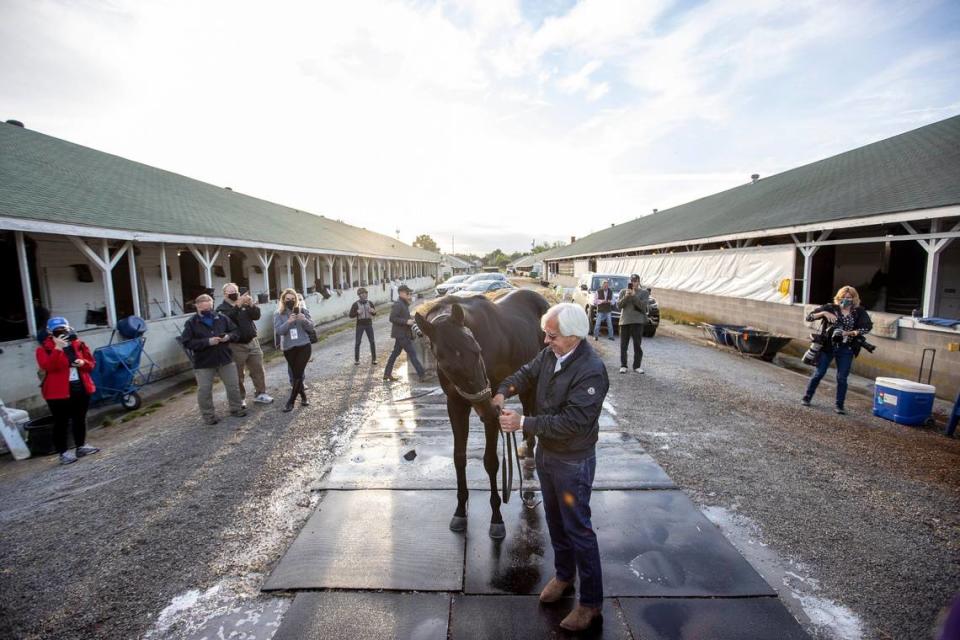 Trainer Bob Baffert stands with Kentucky Derby winner Medina Spirit outside his barn on the backside at Churchill Downs in Louisville on May 2, the day after the race.