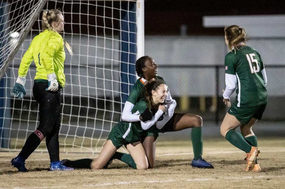 Dolphin Lexi Clark celebrates her overtime goal with teammate Zamiyah Hill. Mosley and Arnold faced off at Gavlak Stadium in the District 2-5A final with the Dolphins coming out on top 2-1 in overtime.