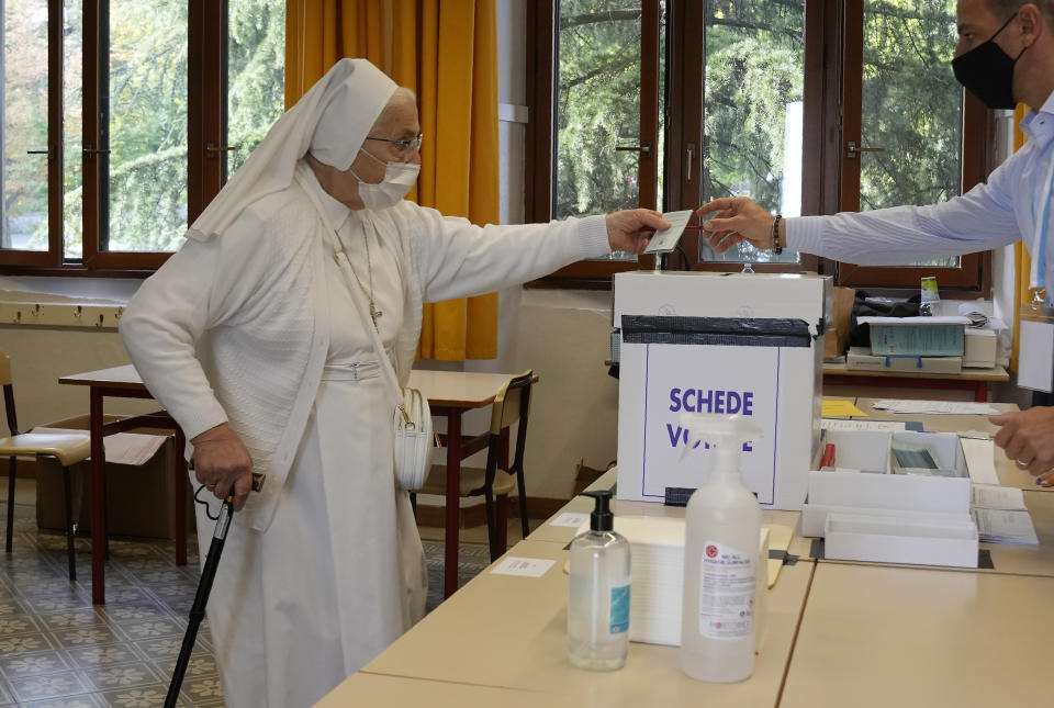 A nun casts her ballot for the abortion referendum at a polling station in San Marino, Sunday, Sept. 26, 2021. Tiny San Marino is one of the last countries in Europe which forbids abortion in any circumstance — a ban that dates from 1865. Its citizens are voting Sunday in a referendum calling for abortion to be made legal in the first 12 weeks of pregnancy. (AP Photo/Antonio Calanni)