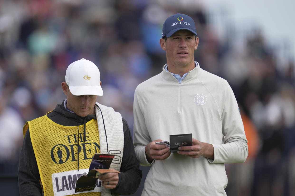 South Africa's Christo Lamprecht (amateur) checks the yardage for the 4th hole on the first day of the British Open Golf Championships at the Royal Liverpool Golf Club in Hoylake, England, Thursday, July 20, 2023. (AP Photo/Kin Cheung)