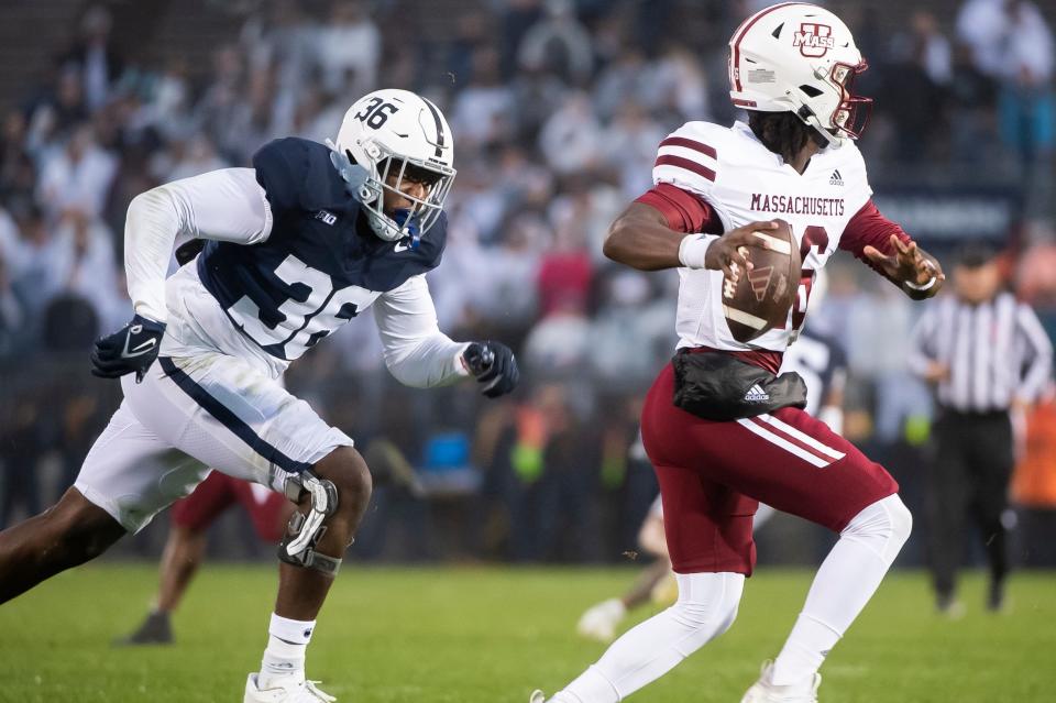Penn State defensive end Zuriah Fisher (36) pursues Massachusetts quarterback Ahmad Haston in the second half of a NCAA football game against Massachusetts Saturday, Oct. 14, 2023, in State College, Pa. The Nittany Lions won, 63-0.
