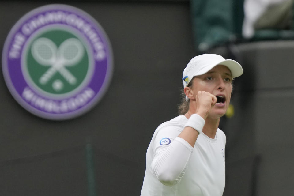 Poland's Iga Swiatek celebrates defeating China's Zhu Lin in the first round women's singles match on day one of the Wimbledon tennis championships in London, Monday, July 3, 2023. (AP Photo/Alastair Grant)