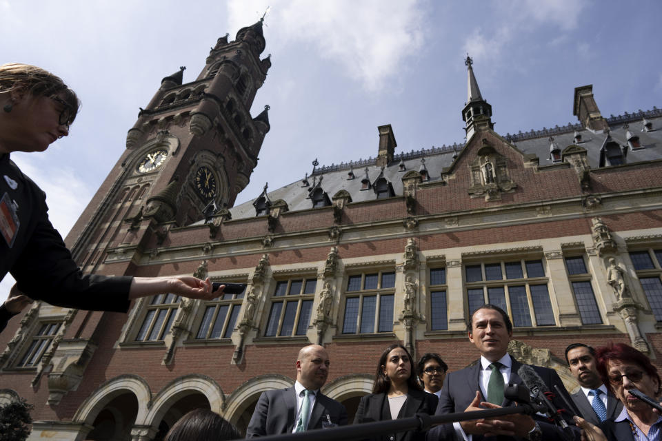 Mexico's legal advisor Alejandro Celorio Alcantar, right, and agent and ambassador Carmen Moreno Toscano, far right, give a brief statement outside the International Court of Justice in The Hague, Netherlands, Tuesday, April 30, 2024. Mexico is taking Ecuador to the top U.N. court Tuesday, accusing the nation of violating international law by storming the Mexican Embassy in Quito to arrest Jorge Glas, a former vice president who had just been granted asylum by Mexico. (AP Photo/Peter Dejong)