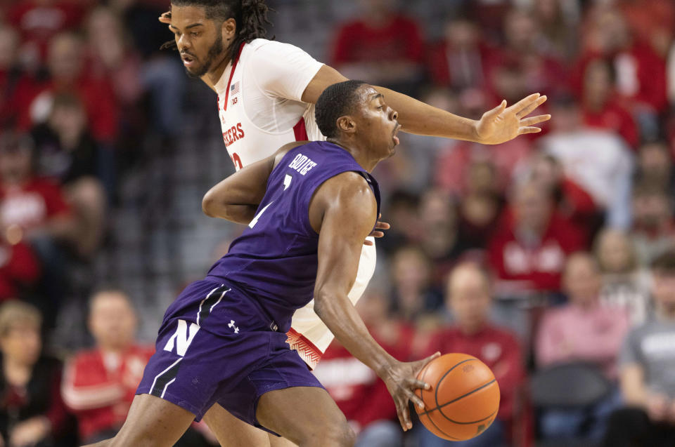 Northwestern's Chase Audige, front, drives against Nebraska's Derrick Walker during the first half of an NCAA college basketball game Wednesday, Jan. 25, 2023, in Lincoln, Neb. (AP Photo/Rebecca S. Gratz)