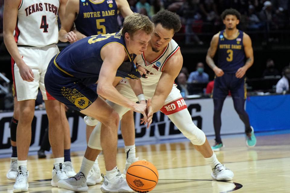 Mar 20, 2022; San Diego, CA, USA; Texas Tech Red Raiders forward Marcus Santos-Silva (14) and Notre Dame Fighting Irish guard Dane Goodwin (23) fight for a rebound in the second half during the second round of the 2022 NCAA Tournament at Viejas Arena. Mandatory Credit: Kirby Lee-USA TODAY Sports